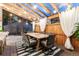 Outdoor covered patio area featuring a dining table set, grill, bar with sink, and overhead string lights at 2867 S Oswego Ct, Aurora, CO 80014
