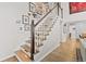 Beautiful staircase featuring hardwood steps and white railing adjacent to a gallery wall at 2867 S Oswego Ct, Aurora, CO 80014