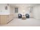 Finished basement with dual chairs, neutral carpet, and built-in shelving at 450 Steele St, Denver, CO 80206