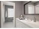 Modern bathroom with a tiled shower, patterned walls, and floating vanity at 450 Steele St, Denver, CO 80206