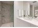 Elegant bathroom boasts a glass shower, marble tile, and sleek fixtures at 450 Steele St, Denver, CO 80206