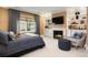 Cozy bedroom featuring a fireplace, TV, and built-in shelving at 450 Steele St, Denver, CO 80206