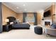 Comfortable bedroom with a fireplace, TV, and neutral decor at 450 Steele St, Denver, CO 80206