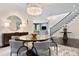 Elegant dining room featuring a chandelier, modern furniture, and a staircase in the background at 450 Steele St, Denver, CO 80206