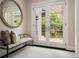 Elegant foyer with french doors that let in tons of natural light and a decorative mirror at 450 Steele St, Denver, CO 80206