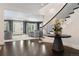 Spacious foyer with dark wood floors, staircase, and access to the living room at 450 Steele St, Denver, CO 80206