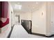 Hallway with dark floors, white walls, a skylight, and a view into another room at 450 Steele St, Denver, CO 80206