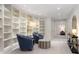 Charming library with floor to ceiling curved bookshelves, and stylish seating at 450 Steele St, Denver, CO 80206
