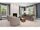 Bright living room with a fireplace, large windows, and comfortable seating at 450 Steele St, Denver, CO 80206