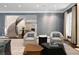 Open-concept living room with staircase, elegant furniture, and neutral color palette at 450 Steele St, Denver, CO 80206