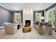 Cozy living room with fireplace, plush seating, and natural light filtering through the windows at 450 Steele St, Denver, CO 80206
