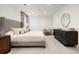 Elegant main bedroom with king bed, dresser, and window with curtains at 450 Steele St, Denver, CO 80206