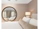 A luxurious main bedroom with a large round mirror and bedside lamps at 450 Steele St, Denver, CO 80206