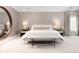 Serene main bedroom with neutral tones, a large mirror, and ample natural light from the window at 450 Steele St, Denver, CO 80206