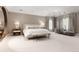 Serene main bedroom with neutral tones, ample natural light, and comfortable seating area at 450 Steele St, Denver, CO 80206