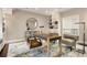 Stylish home office with built-in bookshelves and neutral toned walls at 450 Steele St, Denver, CO 80206