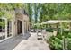 Spacious outdoor patio area with stone flooring, elegant seating arrangements, and lush landscaping at 450 Steele St, Denver, CO 80206