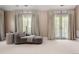 Relaxing sitting area featuring soft lighting and french doors with natural light at 450 Steele St, Denver, CO 80206