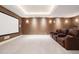 Home theater with projector screen, leather seating, and soft wall lighting at 450 Steele St, Denver, CO 80206