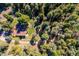 A beautiful aerial view of a house surrounded by lush trees, offering privacy and a sense of seclusion at 25357 Snyder Ave, Conifer, CO 80433