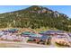 Aerial view of town with shopping center and scenic mountain backdrop at 25357 Snyder Ave, Conifer, CO 80433