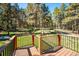 This backyard deck overlooks the vast fenced-in backyard and a scenic walking path at 25357 Snyder Ave, Conifer, CO 80433