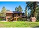 Spacious backyard with mature trees, shed, and deck with access to home at 25357 Snyder Ave, Conifer, CO 80433