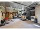 Unfinished basement with a workout bench, treadmill, shelving, and laundry area at 25357 Snyder Ave, Conifer, CO 80433