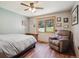 Comfortable bedroom with a scenic backyard view, wood floors, and a relaxing armchair at 25357 Snyder Ave, Conifer, CO 80433