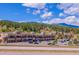 Commercial building with numerous parking spaces and many retail storefronts in a mountain community at 25357 Snyder Ave, Conifer, CO 80433