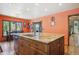 Open kitchen with central island and wood cabinets, ample seating and natural light at 25357 Snyder Ave, Conifer, CO 80433