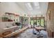 Bright sunroom featuring skylights, hardwood floors, large windows, and shelving at 25357 Snyder Ave, Conifer, CO 80433