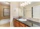 Well-maintained bathroom featuring a vanity with good lighting and a shower/tub combo at 11917 Monroe St, Thornton, CO 80233