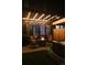 Outdoor entertaining area with a fire pit and a hot tub, illuminated by pergola lights at 527 Fox St, Denver, CO 80204