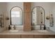 Elegant bathroom with double vanity, arched mirrors, and stylish lighting fixtures at 527 Fox St, Denver, CO 80204