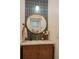Charming bathroom vanity with striking blue tile backsplash and gold hardware and accents at 527 Fox St, Denver, CO 80204