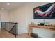 Open-concept hallway with wooden desk and mounted TV at 527 Fox St, Denver, CO 80204