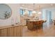 Modern kitchen featuring hardwood floors, an island with barstools and pendant lights, and stainless steel appliances at 527 Fox St, Denver, CO 80204