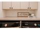Efficient laundry room with modern appliances, ample counter space and upper cabinets at 527 Fox St, Denver, CO 80204