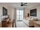 Bright living room with ceiling fan, comfortable sofa, and balcony access at 527 Fox St, Denver, CO 80204