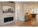Open-concept living room with a fireplace, console, and a glimpse into the kitchen with an island and stools at 527 Fox St, Denver, CO 80204