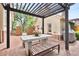 Charming backyard with a pergola, brick patio, and stylish outdoor furniture, perfect for outdoor entertaining at 4535 E Montview Blvd, Denver, CO 80207