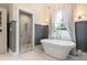 Elegant bathroom featuring a freestanding tub, marble shower, and modern fixtures near a large window at 4535 E Montview Blvd, Denver, CO 80207