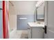 Cozy bathroom with marble countertop, white vanity, and combination shower with a patterned shower curtain at 4535 E Montview Blvd, Denver, CO 80207