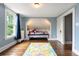 Tranquil bedroom showcasing a built-in bed nook, hardwood floors, and soft blue walls with a large window at 4535 E Montview Blvd, Denver, CO 80207