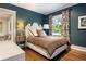 Stylish bedroom with a decorative headboard, hardwood floors, and natural light at 4535 E Montview Blvd, Denver, CO 80207