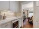 Butler's pantry featuring a marble countertop, sink, and a beverage refrigerator at 4535 E Montview Blvd, Denver, CO 80207