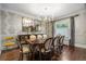 Formal dining room featuring a large dining table, elegant lighting, and stylish wallpaper at 4535 E Montview Blvd, Denver, CO 80207