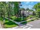 Charming home with manicured lawn, mature trees, and well-maintained landscaping on a sunny corner lot at 4535 E Montview Blvd, Denver, CO 80207