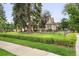 Charming two-story home featuring a beautifully landscaped yard and mature trees at 4535 E Montview Blvd, Denver, CO 80207